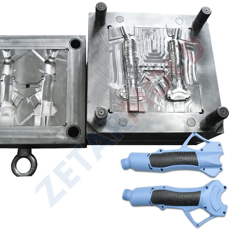 Metal injection mold with two blue handle components placed beside it.
