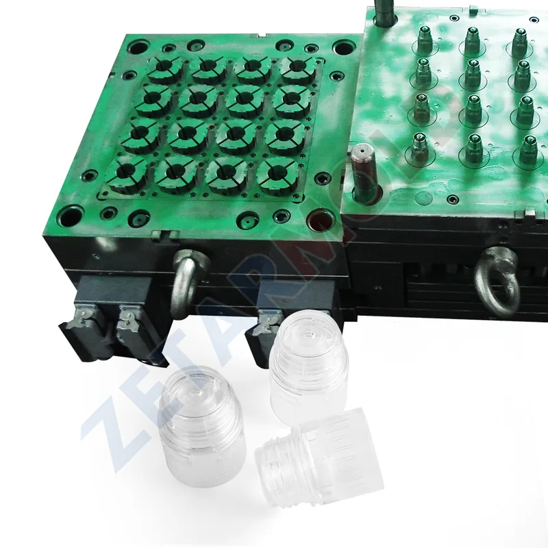 A green injection mold used for creating plastic preforms, with several clear plastic parts displayed in front.