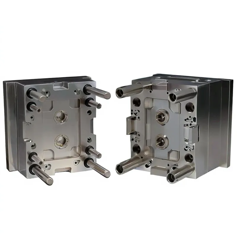 Two halves of a metal plastic injection mold with multiple cylindrical pins and cavities.