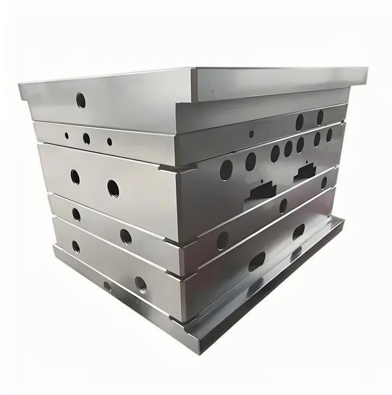 A large metal mold base with multiple layers and circular holes.