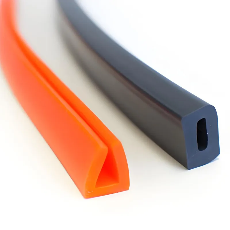 Close-up of two silicone extrusion profiles, one orange with a triangular shape and one black with a rectangular shape and hollow interior.