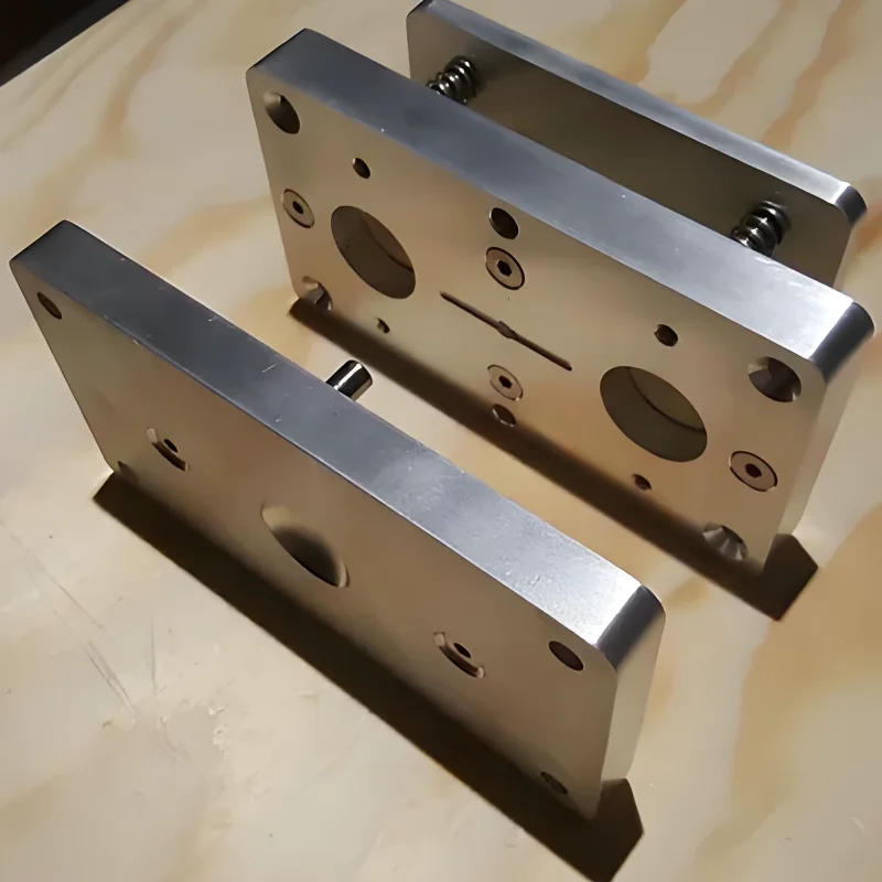 Close-up view of metal machine parts designed for precise fit, illustrating detailed drilling patterns and spring-loaded mechanisms.