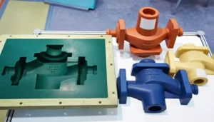 Display of a plastic injection mold with several brightly colored plastic parts, showcasing production capability.
