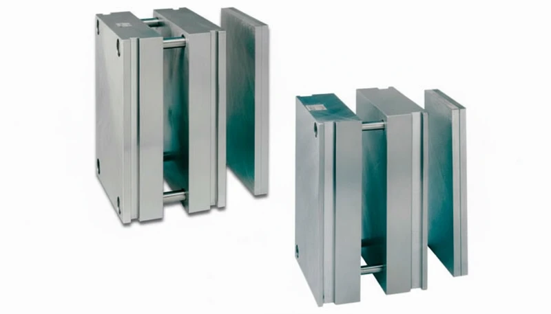 Two steel injection mold bases displayed on a white background, showcasing precise engineering design.