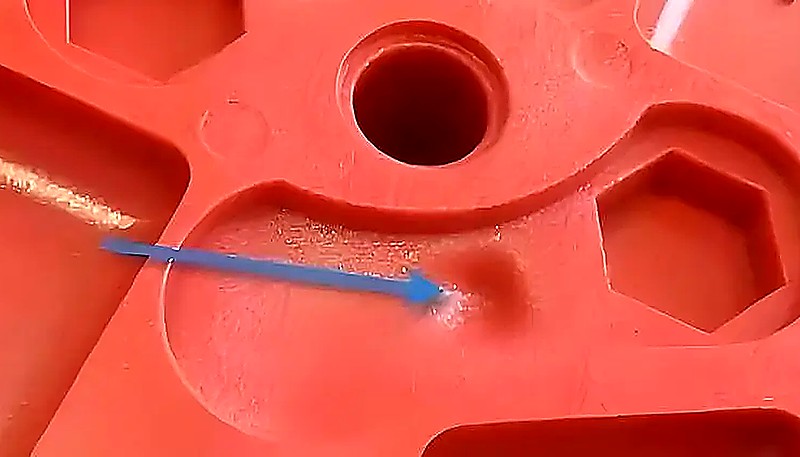 Injection molding surface defect showing depression from insufficient packing pressure