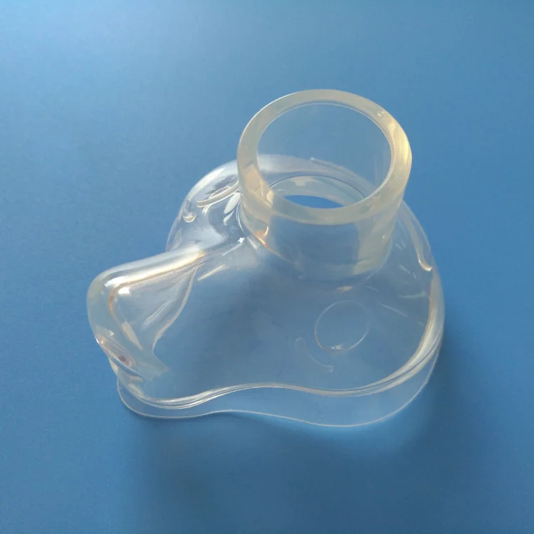 Transparent plastic molded part with cylindrical opening, made using injection molding technology, on a blue surface.